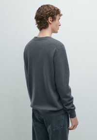 Gray cotton sweatshirt with a round neckline, ribbed cuffs, and a relaxed fit, shown from the back against a light gray background.