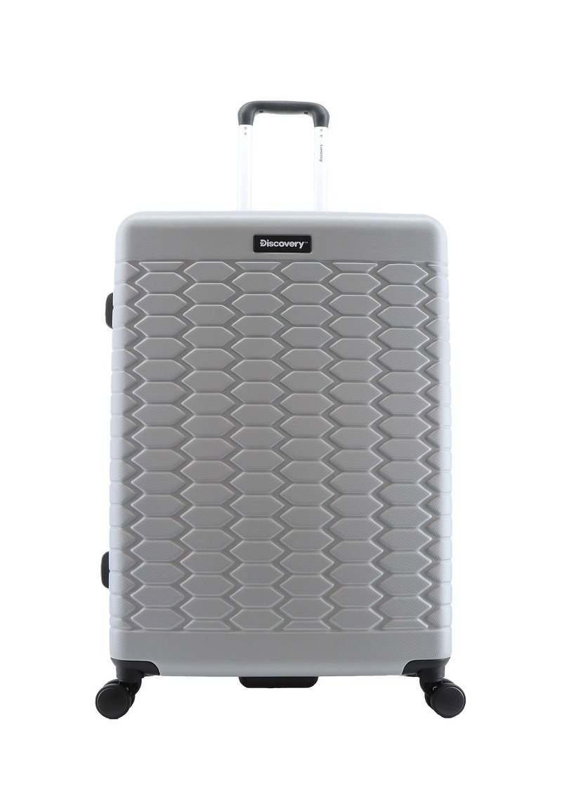 Hartschalentrolley in Silber mit strukturiertem, hexagonalem Muster. Mit einem ausziehbaren Griff und vier schwarzen Drehrollen für die Mobilität ausgestattet.
