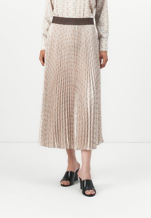 Pleated midi skirt in beige with a textured pattern and dark waistband featuring "JOOP!" logo. Paired with black open-toe heeled mules.