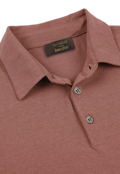 Col polo mauve avec deux boutons gris et une étiquette noire cousue à l'intérieur de l'encolure portant l'inscription « SLOWEAR ZANONE icecotton ».