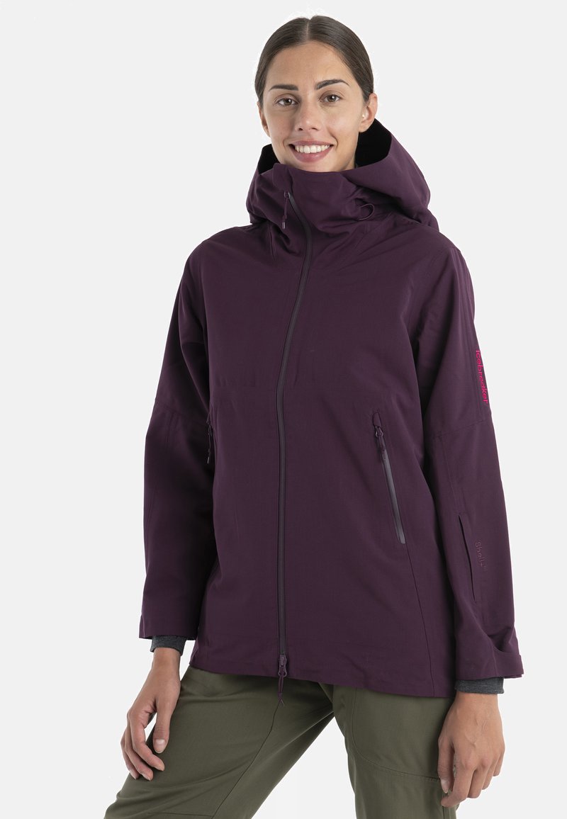 Fioletowa nieprzemakalna kurtka z wysokim kołnierzem, zamek błyskawiczny z przodu i bocznymi kieszeniami. Charakteryzuje się luźnym krojem i subtelnym Brandingiem na rękawie.