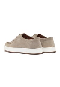 Sneaker in suede beige con suola in gomma bianca liscia, punta tonda e cuciture decorative lungo il bordo superiore. Design minimalista.