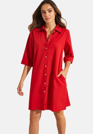 Robe rouge à boutons, faite d'un tissu léger, avec un col, des manches trois-quarts et des poches latérales, offrant une coupe décontractée et droite.