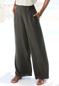 Wide-leg pants in dark green fabric with a smocked waistband, featuring three buttons and side pockets. Smooth texture, relaxed fit.