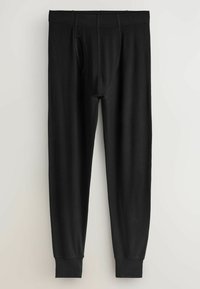 Fekete pamut hosszú nadrág, testhezálló kialakítással, rugalmas derékpánttal és bordázott szegélyekkel. Elöl nyílással a kényelemért.