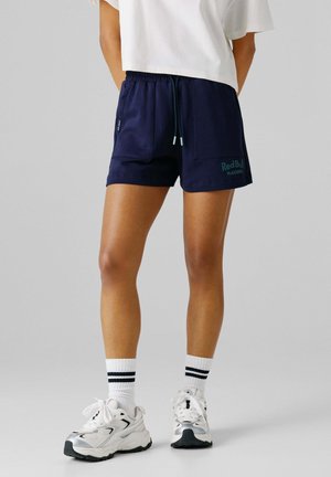 Navy blue athletic shorts with an elastic waistband, drawstring detail, and side pockets. Features "RedBull Racing" logo in mint color.