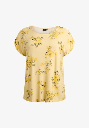 Kollase lillemustriga lühikeste varrukatega top, valmistatud pehmest kangast. Omab ümmargust kaelust ning laialt laotunud kollaseid ja musti lillemotiive pinnal.