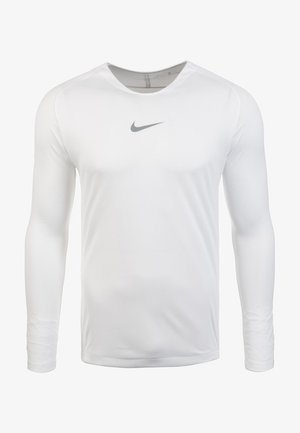 Maglietta sportiva bianca a maniche lunghe con scollatura rotonda. Presenta un logo Nike grigio sul petto. Tessuto liscio e stretch.