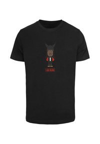 Black T-shirt featuring a cartoon design with a character wearing a black hat and red accents. Text reads "I AM MUSIC" in red.