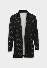 Schwarzer Blazer mit langen Ärmeln und weißen Punkten, ausgestattet mit einem Reverskragen und einem offenen Design. Hergestellt aus einem weichen, leichten Stoff.