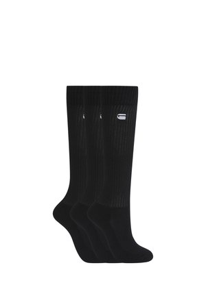 Drei Paar schwarze Crew-Socken mit gerippter Struktur und einem kleinen weißen Logo nahe dem oberen Bündchen, nebeneinander vor weißem Hintergrund angezeigt.