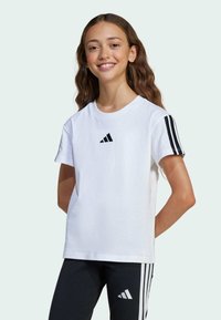 White cotton t-shirt with short sleeves, featuring a black Adidas logo on the chest and black three-stripe accents on the sleeves.