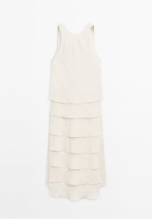 Light beige sleeveless dress featuring a tiered ruffle design with four horizontal layers, hanging against a white background.