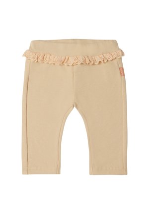 Beige babyleggings med elastisk talje og en dekorativ blonderuffle rundt taljen.
