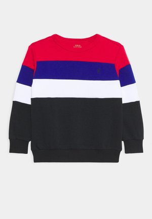 Sweatshirt à manches longues et col rond avec des blocs de couleur horizontaux rouge, bleu, blanc et noir, et un petit logo noir sur la poitrine.