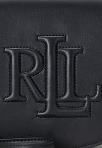 Black leather bag featuring embossed initials "RL" with detailed stitching. Smooth texture and structured shape with a sleek finish.