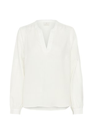 Blusa bianca a maniche lunghe con scollatura a V, caratterizzata da un motivo texturizzato, polsini elasticizzati e una vestibilità rilassata. L'etichetta reca la scritta "Kaite."