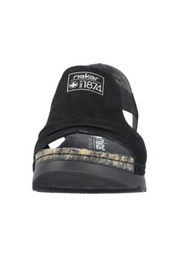 Black suede sandal with open toe and cut-out design. Features a contrast patterned sole and a cushioned insole. Branding on upper strap.