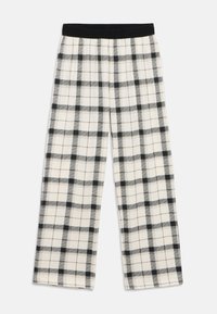 Μαύρο-άσπρο καρό πιτζάμα με μαλακή υφή και φαρδιά γραμμή στα πόδια. Διαθέτει ελαστική μέση για άνεση.