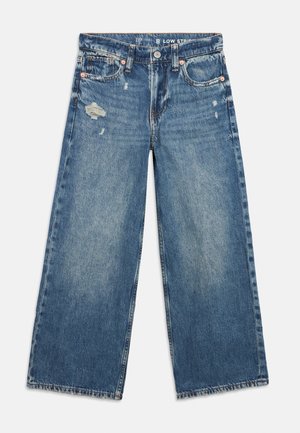 Blue wide-leg denim jeans with distressed details on the left thigh and right pocket, front button closure, and belt loops.