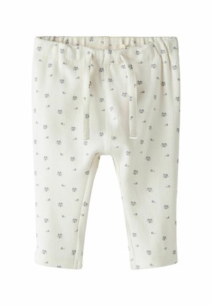 Katoenen geribbelde broek in crème met een bloemenprint. Bevat een elastische tailleband en een trekkoorddetail. Met boorden bij de enkels.