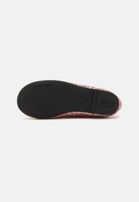 Zapato de ballet plano con parte superior de purpurina en color rosa dorado, suela de goma negra lisa y un logo impreso en la parte inferior. Sin hardware ni acentos visibles.