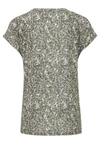Chemise à manches courtes avec un motif floral intégral dans des tons verts, blancs et jaunes, vue de dos.
