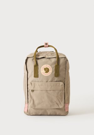 Béžový batoh Fjallraven Kanken s předním kapsou, olivově zelenými madly a růžovými akcenty na popruzích a na nášivce s logem.