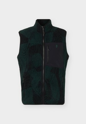 Veste polaire à motif vert foncé et noir avec col montant, fermeture éclair sur le devant et poche poitrine zippée noire avec petit logo.