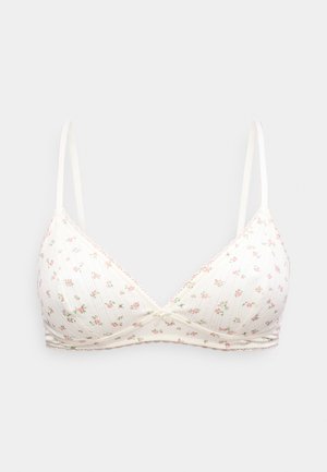 Άσπρο σουτιέν με μαλακά φλις και δαντέλα στο τελείωμα, με λεπτές ρυθμιζόμενες τιράντες και μικρό ροζ λουλουδάτο σχέδιο σε ανοιχτό φόντο.