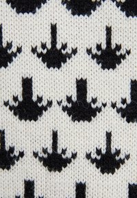 Tissu tricoté avec un motif répété de silhouettes noires ressemblant à des parapluies sur un fond crème. La texture est douce et laineuse.