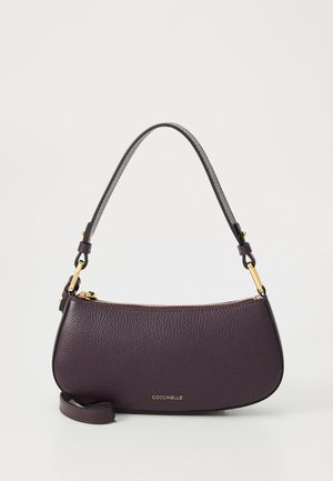 Purple leather handbag with a curved shape, featuring a top zipper closure and a detachable shoulder strap. Gold-tone hardware accents.