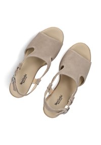 Beige suede sandals with cut-out design, ankle strap, and silver hardware. Smooth inner lining with brand logo on the insole.