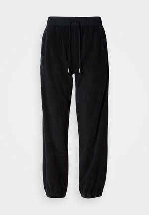 Črne flis hlače s elastičnim pasom, nastavljivo vrvico in ožjimi nogavicami. Teksturirana tkanina z stranskimi žepi.