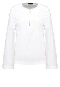 Top bianco a maniche lunghe con scollatura rotonda e dettaglio con zip frontale. Il materiale è liscio, con una vestibilità strutturata e senza motivi visibili.