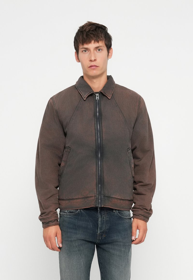 Dark gray denim jacket with a collared neckline, front zipper, and patch pockets. Features raglan sleeves and a slightly faded texture.