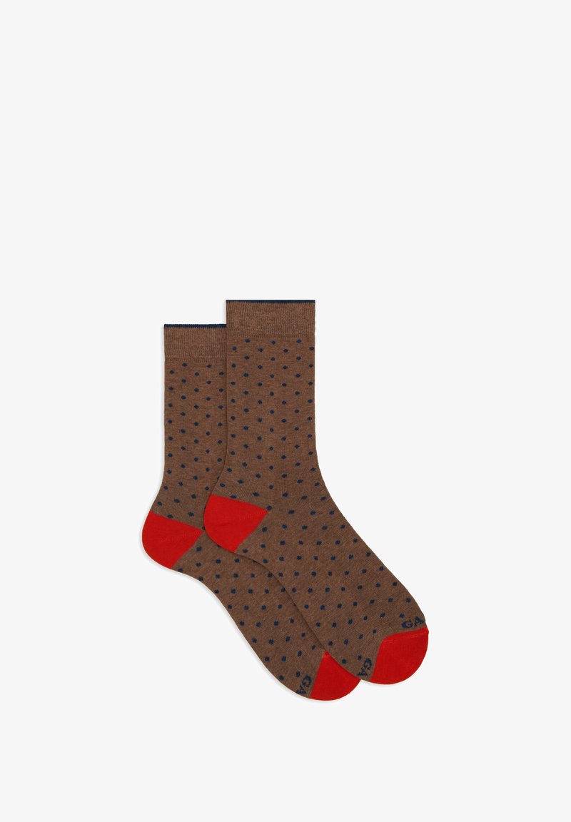 Pair of brown socks with small dark blue polka dots and contrasting bright red toes and heels, laid flat on a white background.
