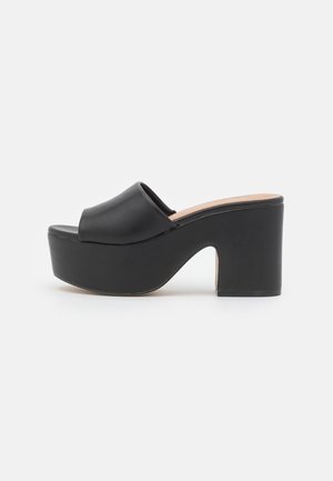 Call it Spring Heeled mules - black