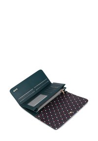 Teal leather wallet open, featuring multiple card slots, a zippered compartment, and a polka dot interior in dark red and grey tones.