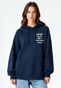 Sweat à capuche bleu marine avec une poche kangourou, arborant un texte blanc indiquant "Parfois, tout ce dont vous avez besoin, c'est de 100 millions de dollars", coupe décontractée.