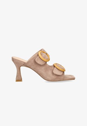 Mules de ante beige con tacón, con dos apliques texturizados superpuestos y acentos circulares amarillos. Diseño de punta abierta con un tacón de altura media.