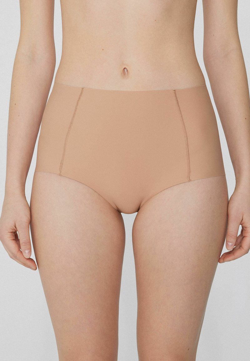 Béžové vysoké kalhotky vyrobené z hladkého materiálu s bezšvým designem a jemnými švy, které poskytují plné pokrytí.