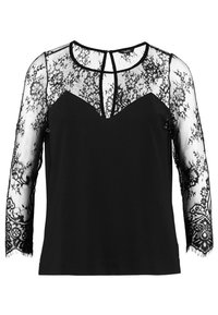 Blusa nera con un davanti opaco e maniche lunghe in pizzo trasparente con motivi floreali, bordi scallop e dettaglio a oblò sul retro.