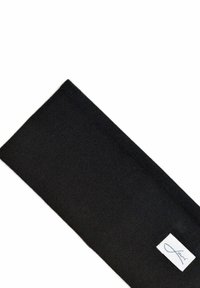 Black fabric headband with a smooth texture and a rectangular shape. Features a small white label with blue stitching on one end.
