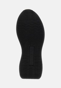 Black rubber shoe sole with a wavy texture. Features a rectangular logo in the center and smooth edges.