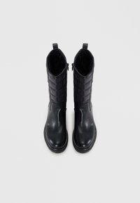 Black ankle boots featuring a shiny leather front, quilted fabric upper, smooth texture, and side zipper for easy wear.