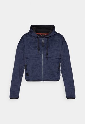 Jachetă scurtă de culoare bleumarin, cu model texturat în ondulație, fermoar frontal, glugă cu șnur și două buzunare laterale cu fermoar.