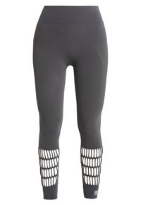 Šedé legíny vyroben�é z elastického materiálu s vysokým pasem, obsahující síťové výřezy na lýtkách a hladkou texturu po celém povrchu.