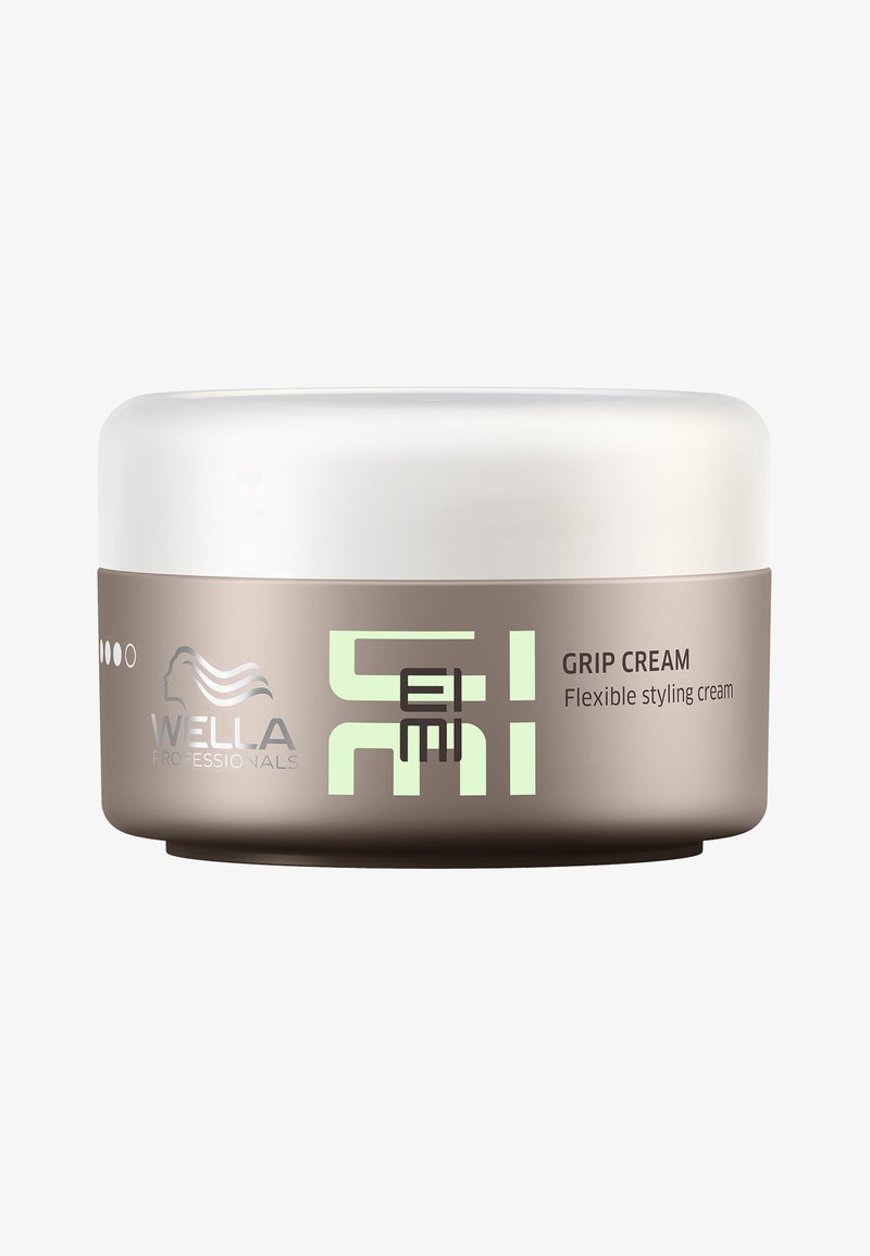 Wella Professionals Grip Cream in einem runden, beigefarbenen Behälter mit einem weißen Deckel. Das Etikett zeigt grünen Text und ein graues Logo. Flexible Styling-Creme.