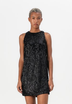 Black sleeveless dress featuring a textured fringe design, with a fitted bodice and loose hem, adding dimensionality and movement.